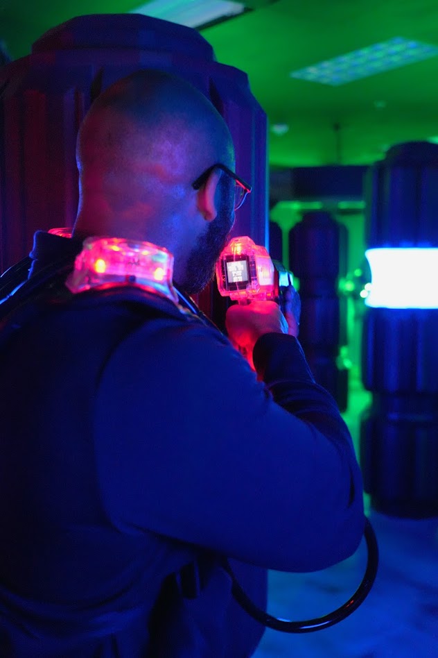 A dad aiming in laser tag