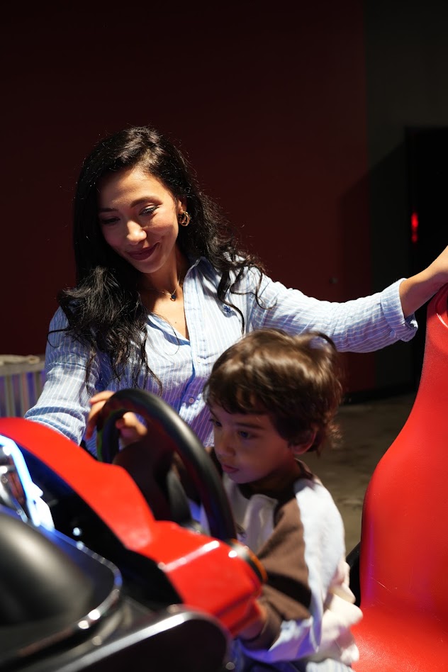 A mom and son at a racing game