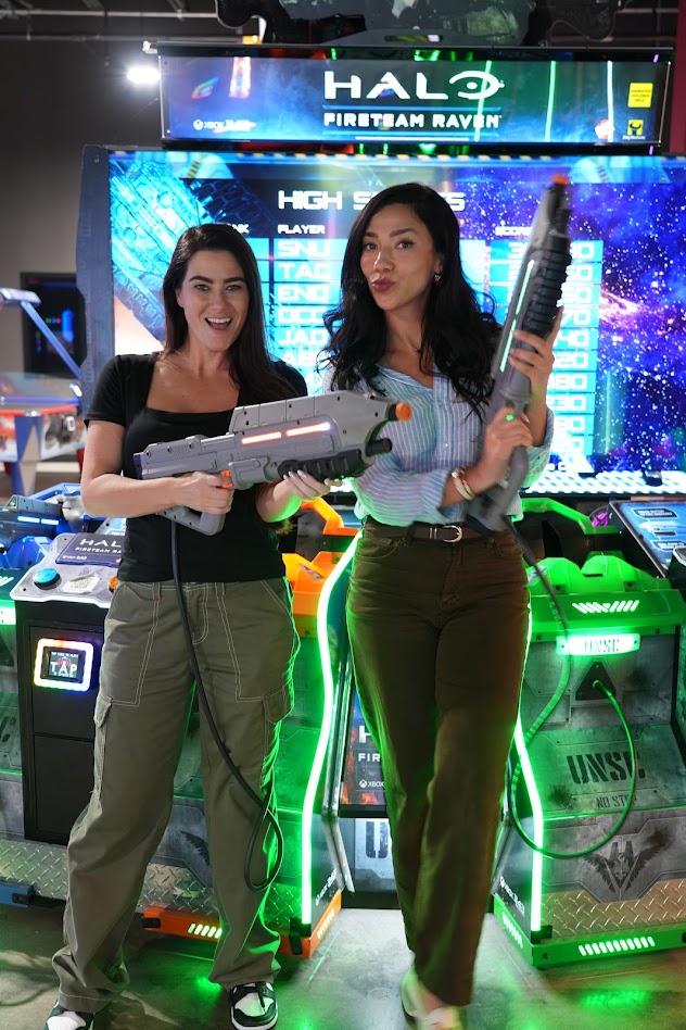 Two moms posing with Halo blasters